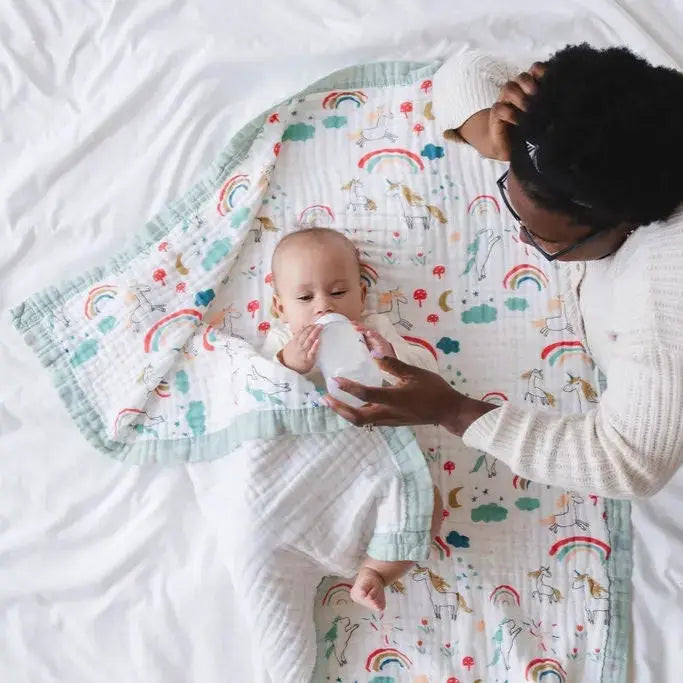 baby using Snuggle Buds muslin blanket for playtime