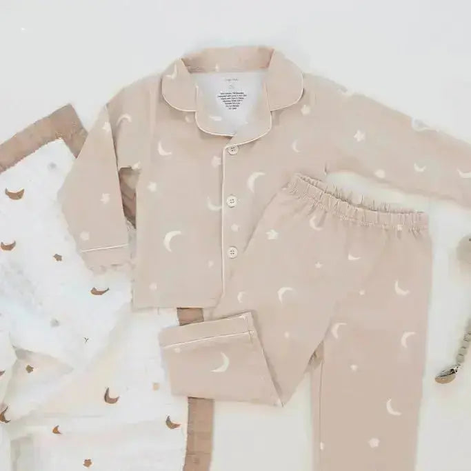 Children's pajama set with moon and star pattern on a white background
