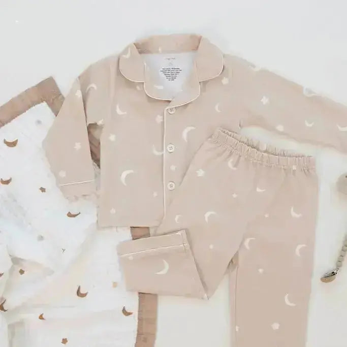 Children's pajama set with moon and star pattern on a white background