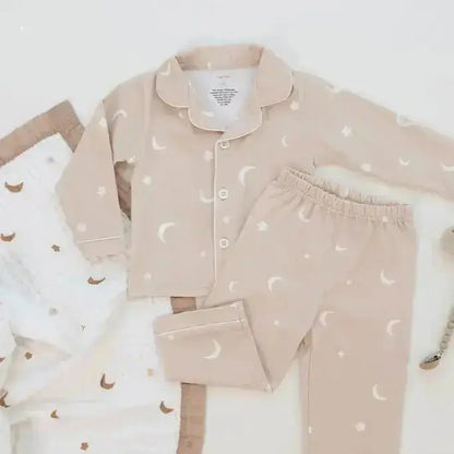 Children's pajama set with moon and star pattern on a white background