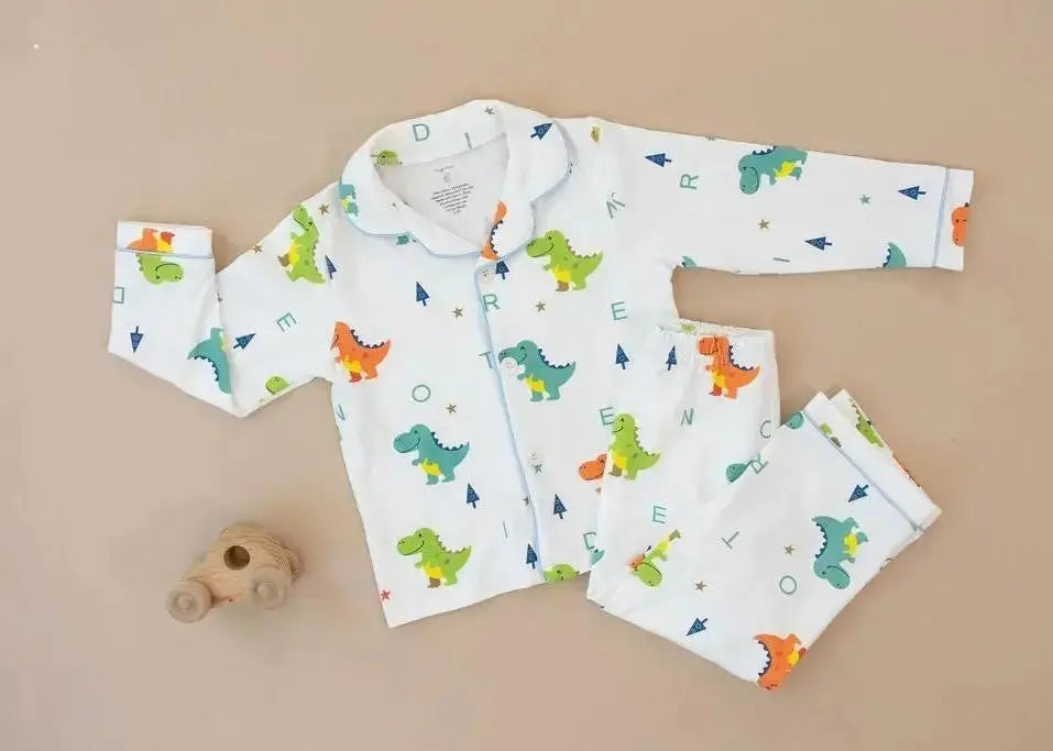 Children's pajama set with dinosaur pattern on a beige background
