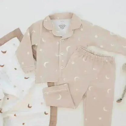Children's pajama set with moon and star pattern on a white background
